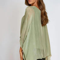 Light green silk batwing-sleeve blouse with round neckline, side view
