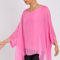 Pink silk batwing-sleeve top, loose drape and curved hem