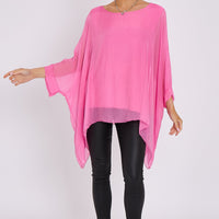 Pink silk batwing-sleeve top, rounded neckline, drapey loose fit