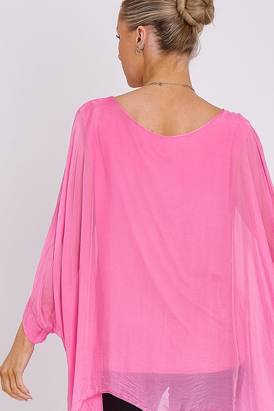 Pink silk batwing-sleeve top back view, rounded neckline, flowing drape