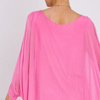 Pink silk batwing-sleeve top back view, rounded neckline, flowing drape