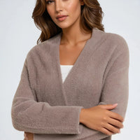 Mocha fluffy open-front cardigan, long sleeves; arms crossed