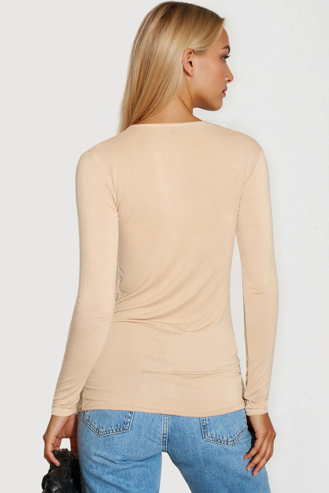 Beige long-sleeve fitted top with V-back and ruched seams