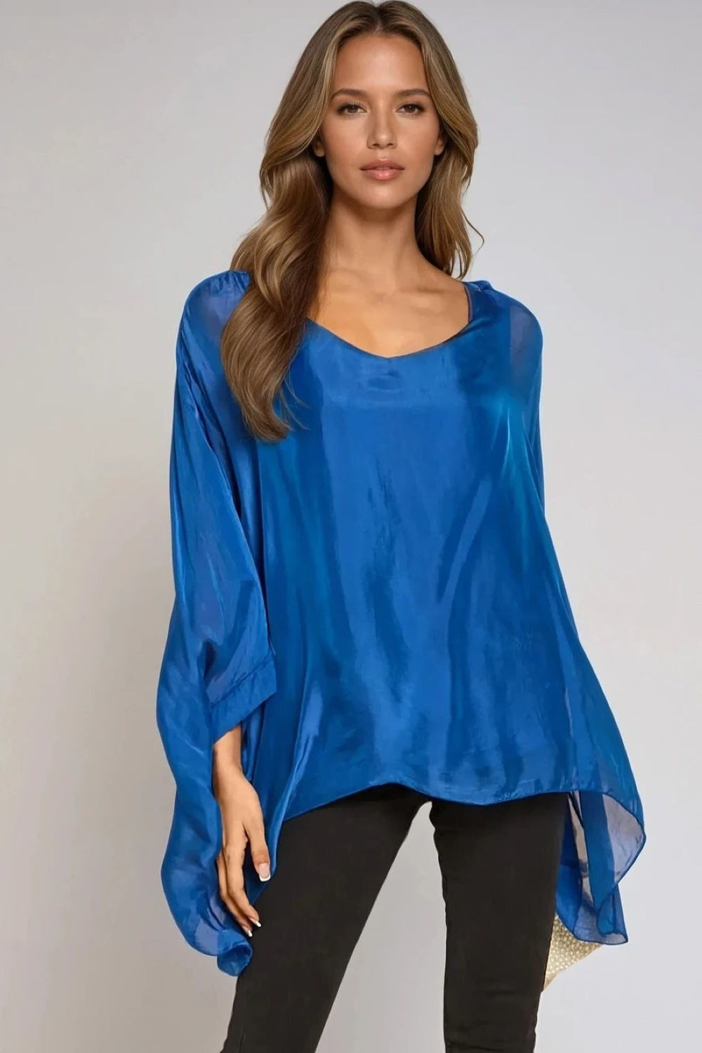 Royal blue silk blouse with round neck and batwing sleeves, flowing drape.