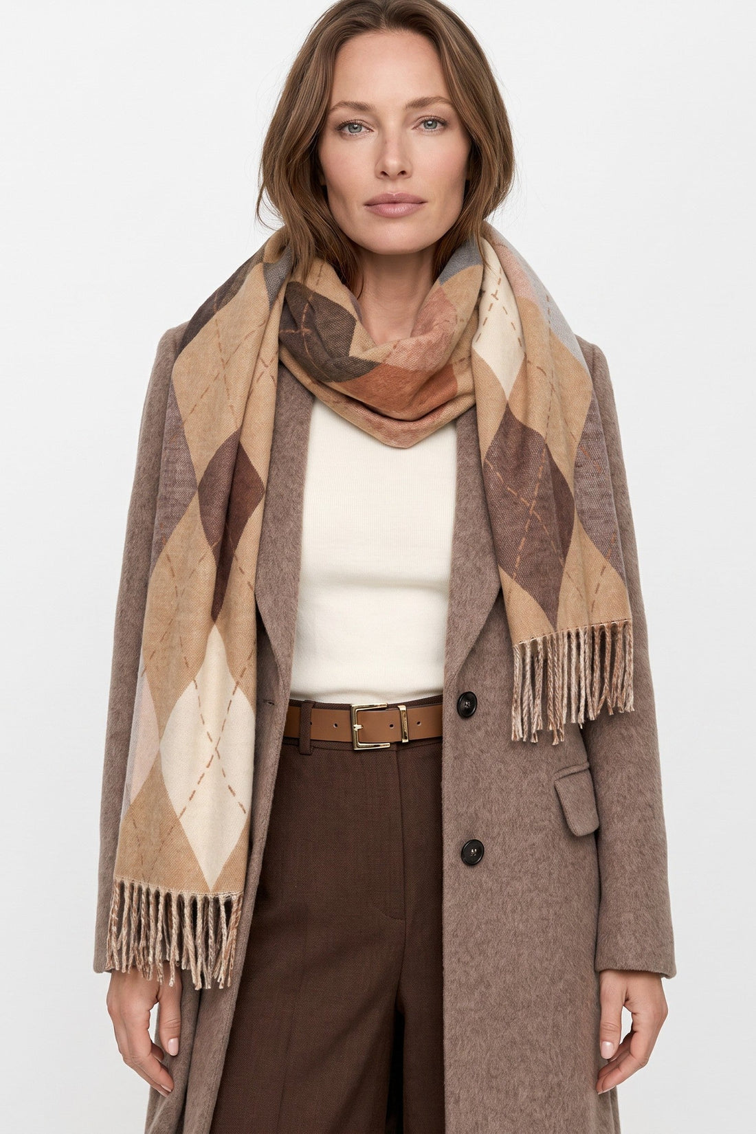 Beige argyle scarf with diamond pattern and fringed ends, draped over shoulders