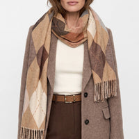 Beige argyle scarf with diamond pattern and fringed ends, draped over shoulders
