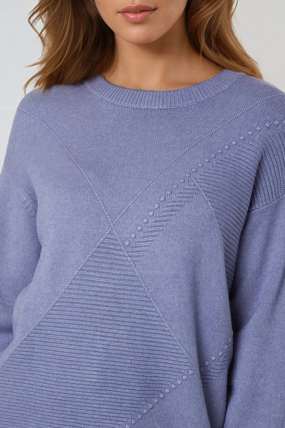 Denim blue knit jumper close-up with round crew neck and geometric diamond stitch