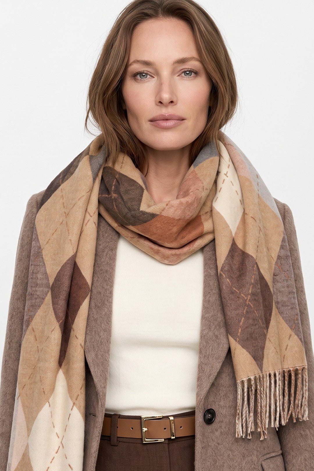 Beige argyle scarf with fringed end, diamond pattern, worn around neck