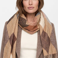 Beige argyle scarf with fringed end, diamond pattern, worn around neck