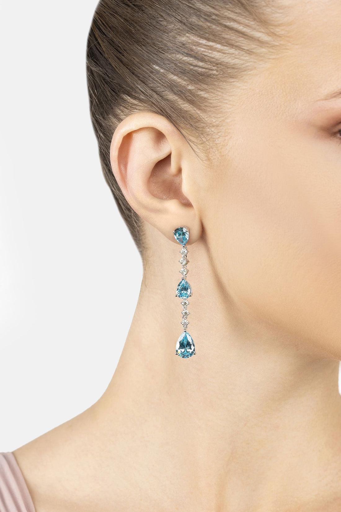 Silver drop earrings with three blue topaz stones and dangling crystal drops