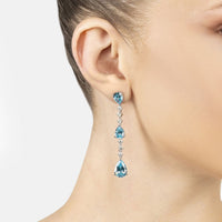 Silver drop earrings with three blue topaz stones and dangling crystal drops