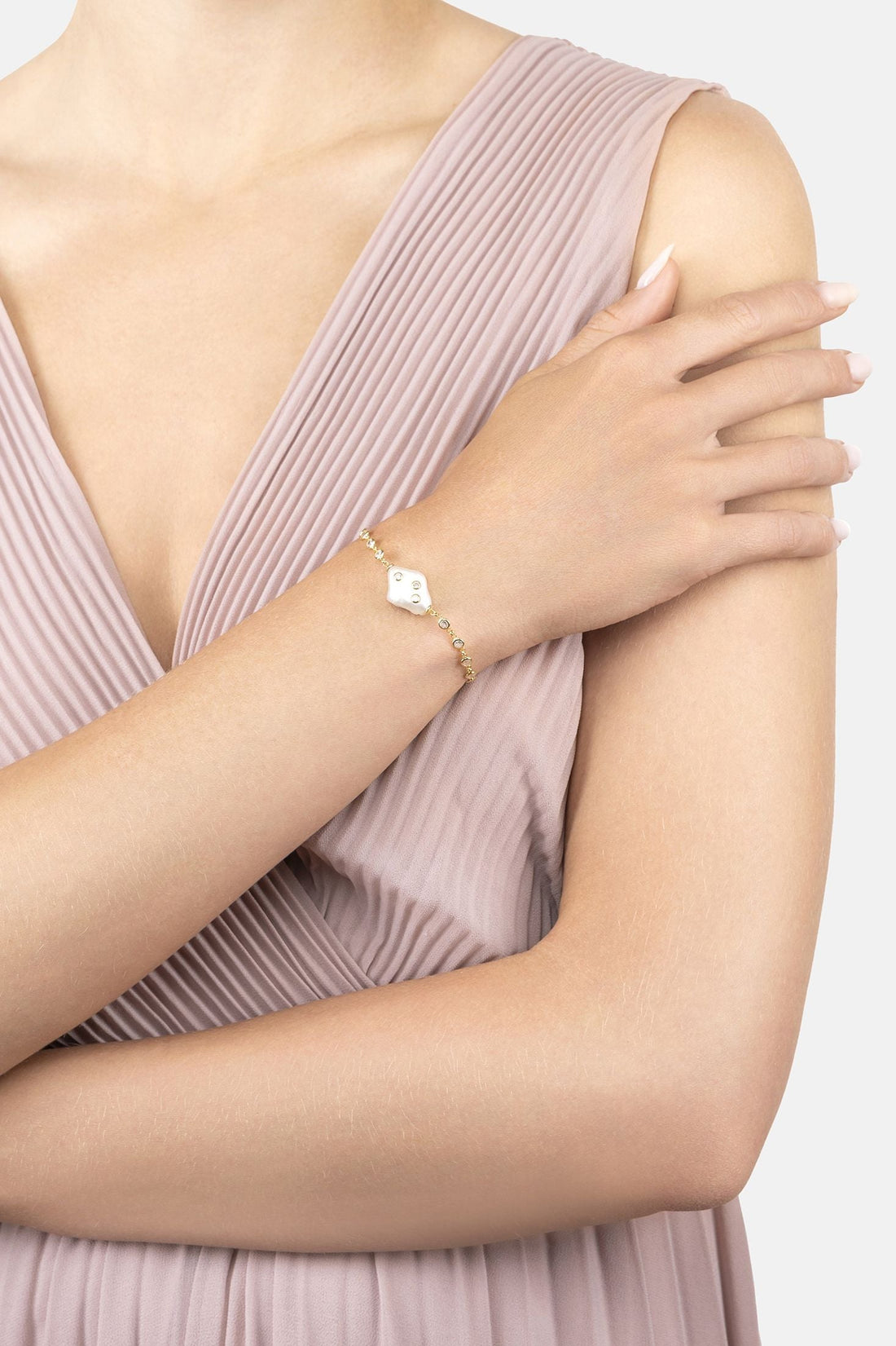 Gold polka-dot pearl bracelet on model&