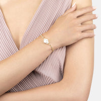 Gold polka-dot pearl bracelet on model's wrist