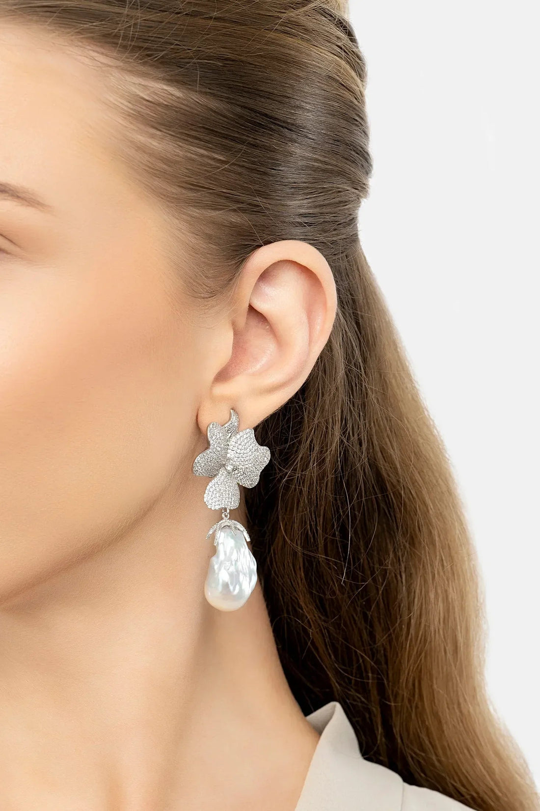 Clip-on earrings: silver glitter flower with white pearl drop, worn on ear