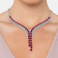 Silver statement necklace with ruby red faceted drops centered at the neckline