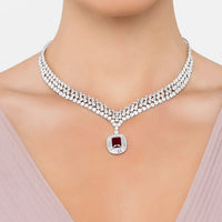 Silver rhinestone statement necklace with ruby-red pendant charm at center