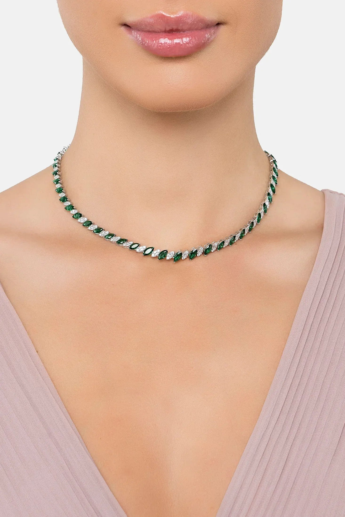 Emerald-green oval-stone tennis necklace on neckline, silver-tone chain