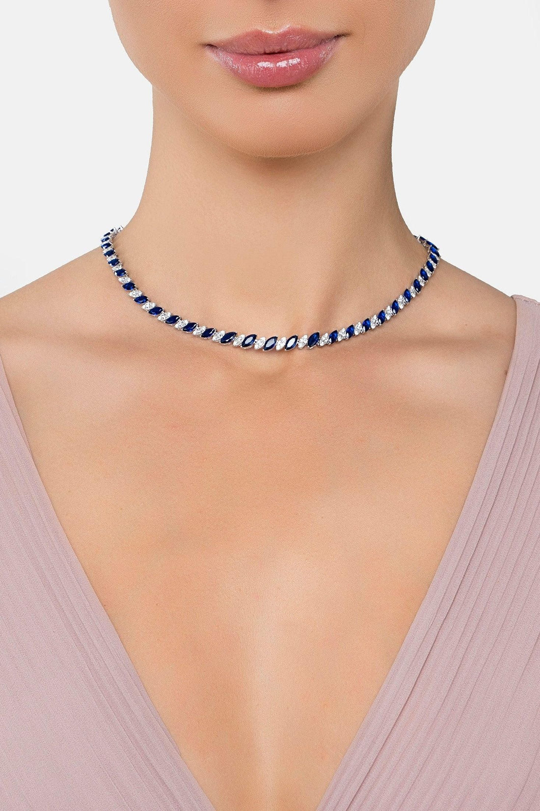 Sapphire blue tennis necklace worn at collar, silver-tone chain with crystal links