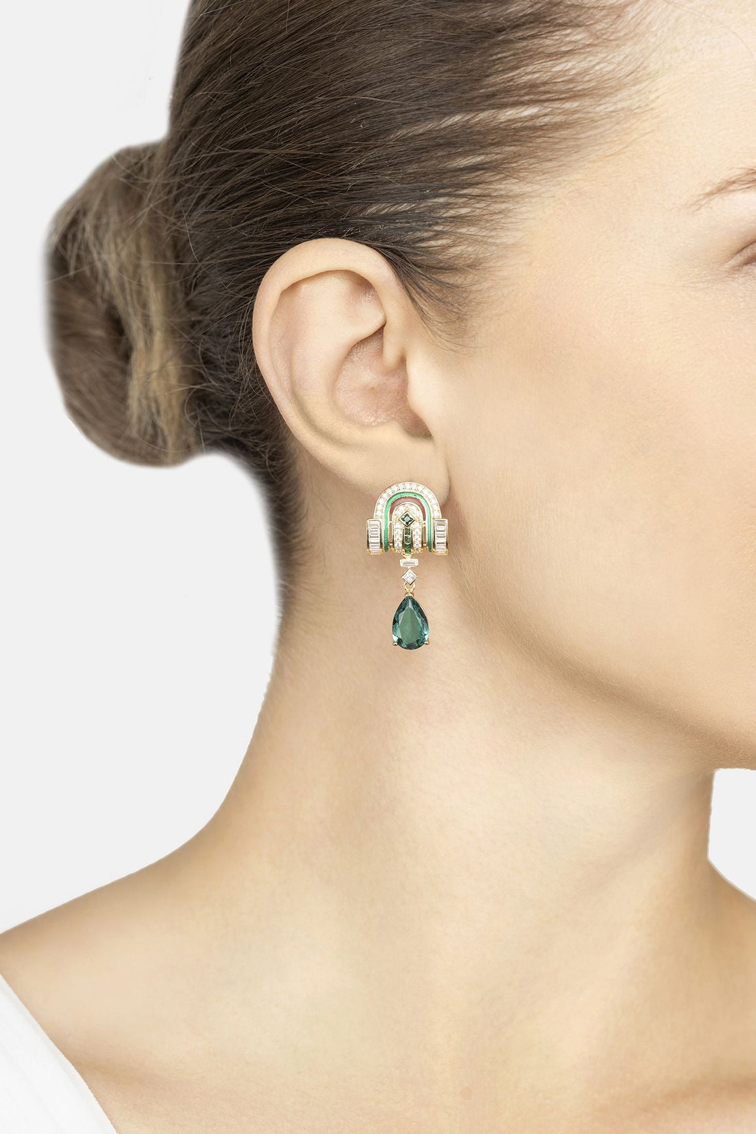 Gold-tone Art Deco drop earrings with emerald-green teardrop dangle on ear