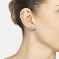 Blue opalite turtle stud earrings on ear with silver posts