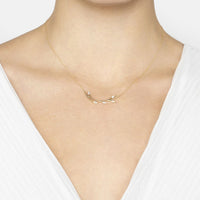 14k gold blooming branch necklace worn on collarbone, leaf-like pendant