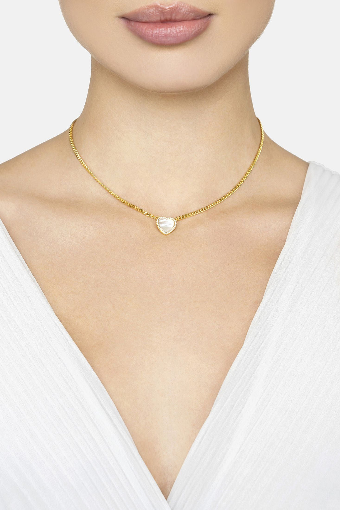 Gold mother-of-pearl heart necklace on neckline with clasp