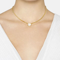 Gold mother-of-pearl heart necklace on neckline with clasp