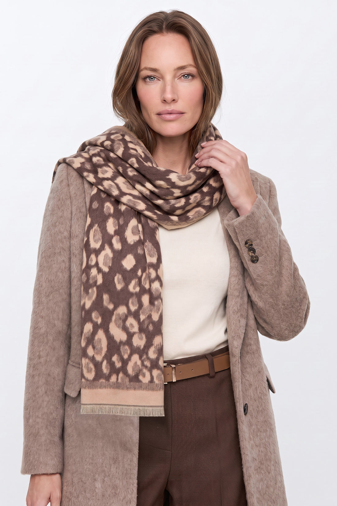 Brown spotted print scarf with fringed ends, draped over shoulders