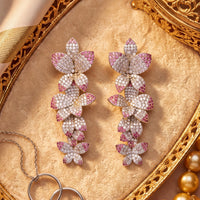 Pink and silver glitter cherry blossom drop earrings, close-up side view