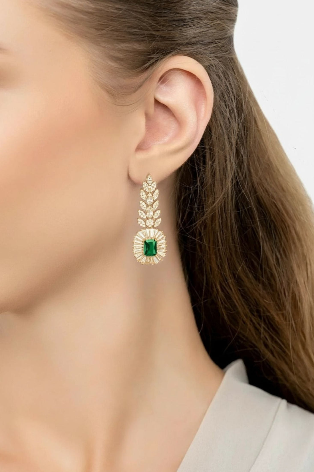 Emerald gold drop earrings with leaf detail and green gemstone