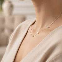 Natural pearl necklace with clustered pearls on a white gold chain, close-up
