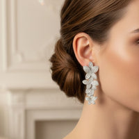 Cherry blossom drop earrings on model, white-silver glitter floral drop