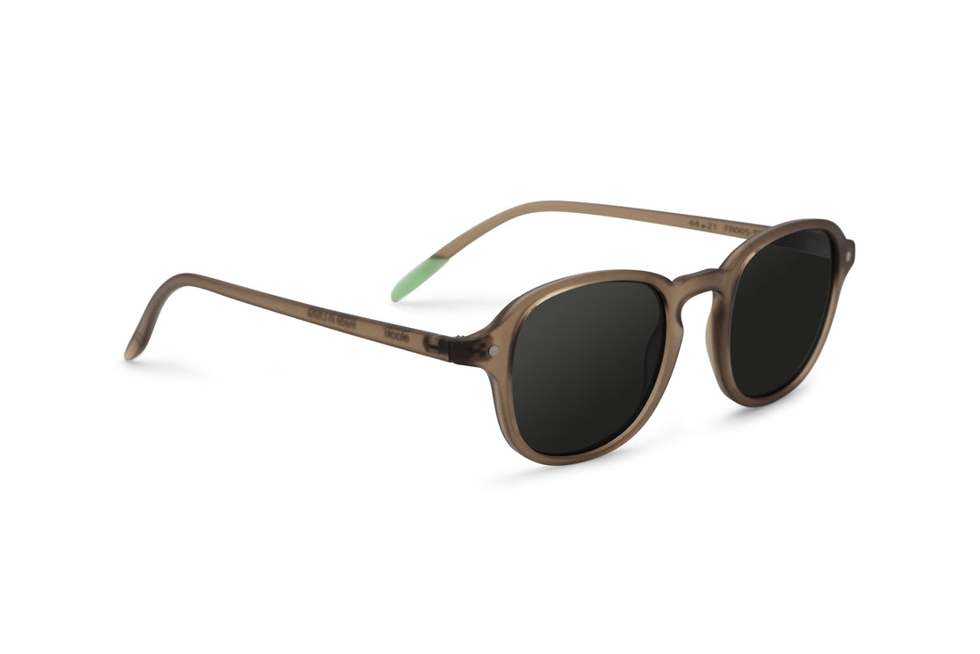 Brown round sunglasses, side view, dark lenses with green temple accents