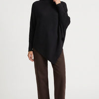 Black high-neck jumper with batwing sleeves and asymmetric hem