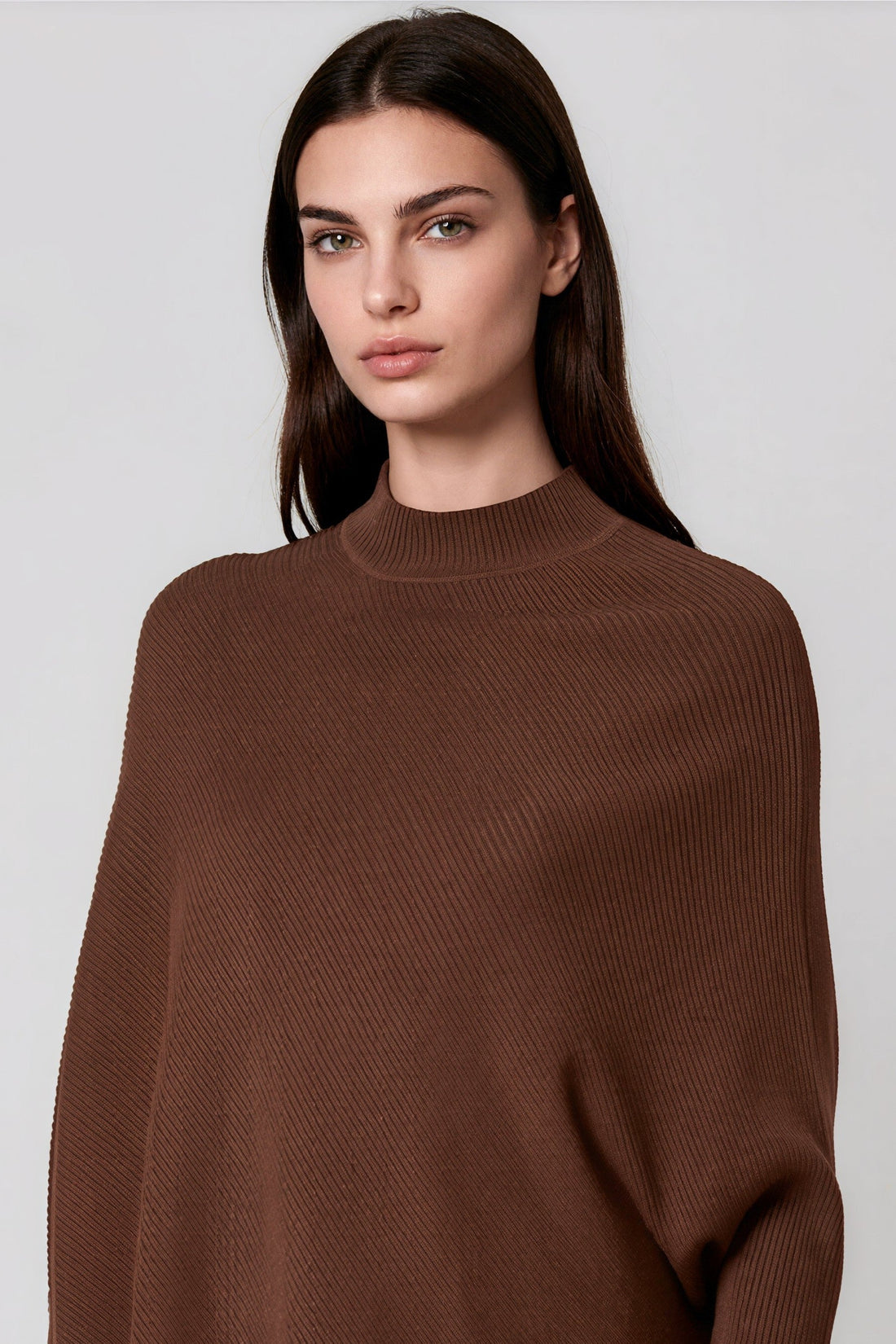 Brown high-neck knit jumper with batwing sleeves and relaxed asymmetric hem