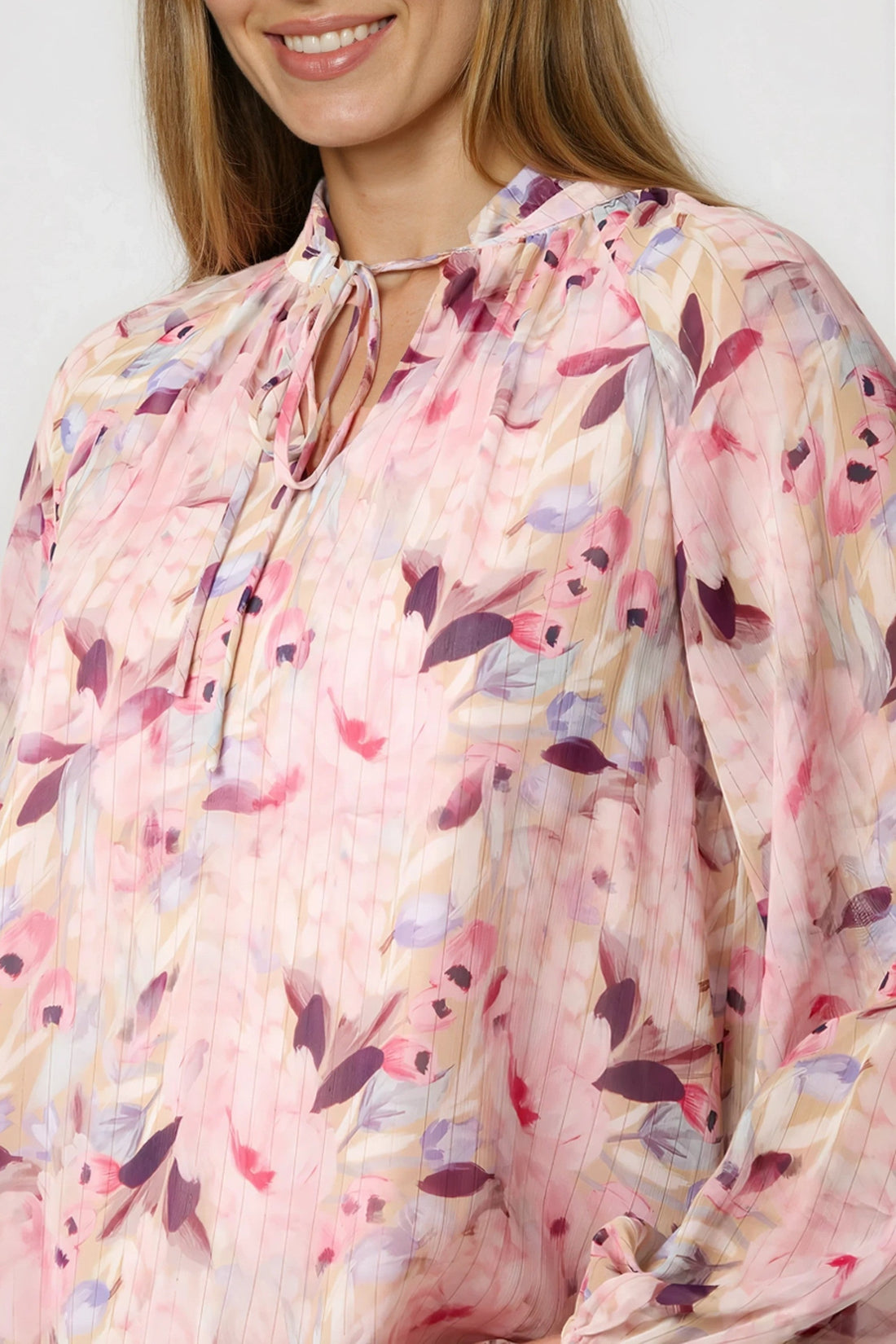 Pink floral tie-neck blouse with pleated neckline, sheer blouson sleeves