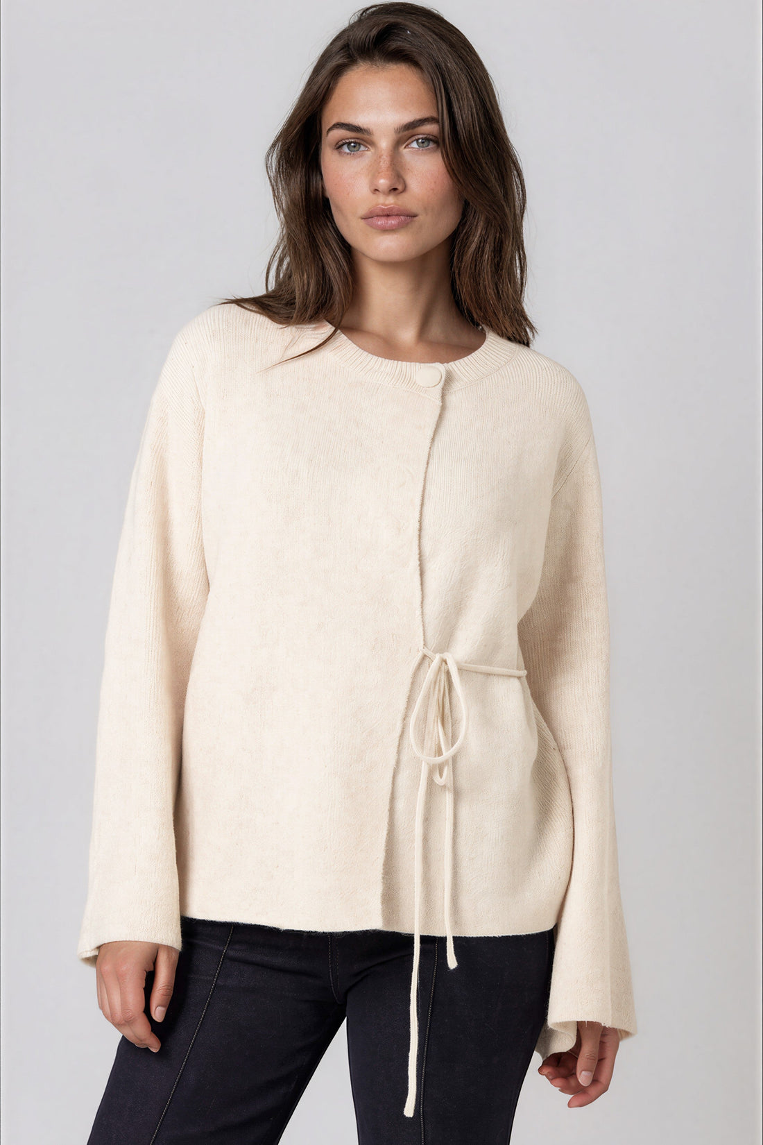 Beige knit cardigan with round neck and side tie, wide sleeves