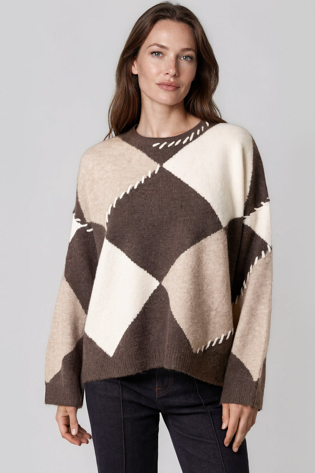 Wool-blend jumper in cream with dark argyle diamonds and contrast zigzag stitch at neckline