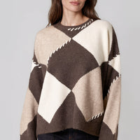 Wool-blend jumper in cream with dark argyle diamonds and contrast zigzag stitch at neckline