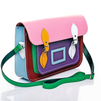 Multicolor leather satchel with pink flap, side view showing buckles and green shoulder strap
