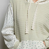 Sage mixed-knit contrast print sleeve hoodie close-up with hood drawstrings and kangaroo pocket