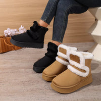 Black round-toe platform boots with faux-fur trim and crisscross straps