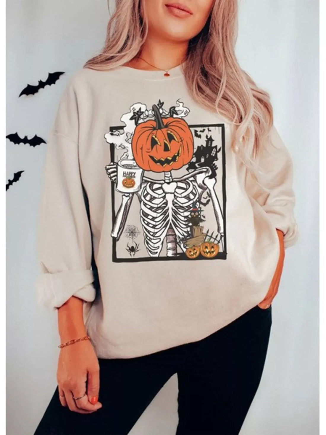 Beige crewneck sweatshirt with skeleton holding jack-o&