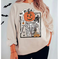 Beige crewneck sweatshirt with skeleton holding jack-o'-lantern graphic