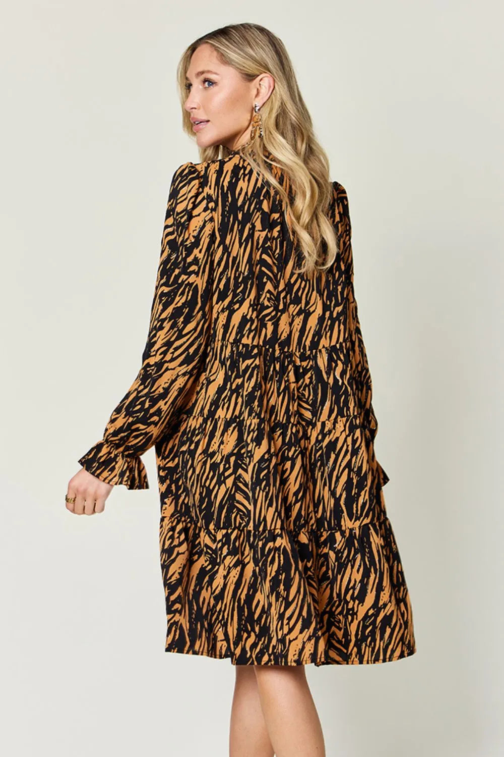 Caramel and black animal-print long-sleeve dress with tiered ruffle details