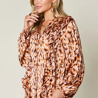 Caramel printed V-neck tunic shirt with ruffle-trim puff sleeves, button front