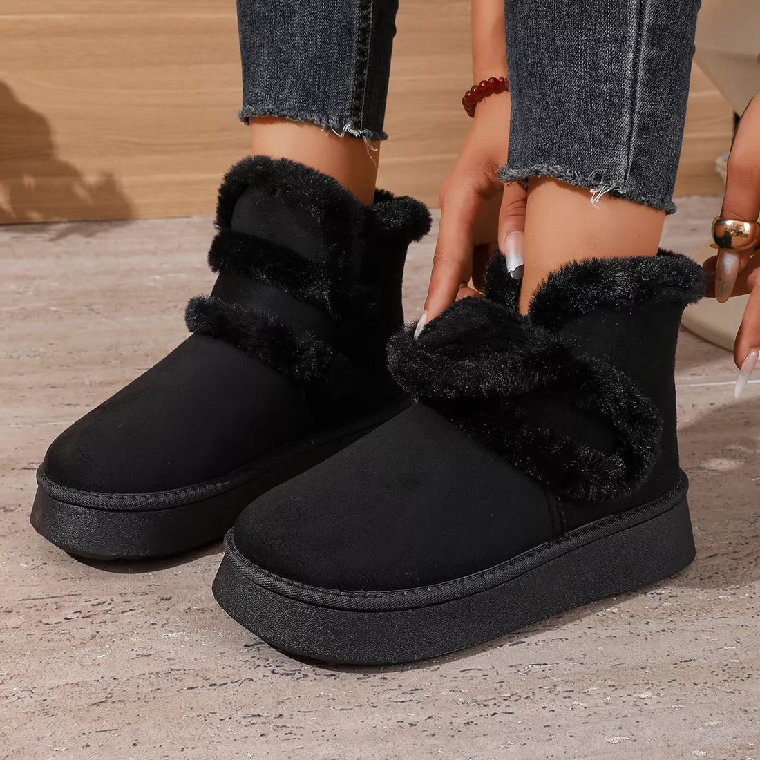 Black round-toe platform boots with thick faux-fur trim and cushioned sole