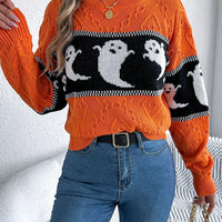Orange textured crewneck sweater with black-and-white ghost motif and ribbed wrist cuffs