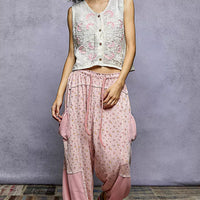 Floral embroidered V-neck sleeveless vest in cream with pink flower motifs and buttons.