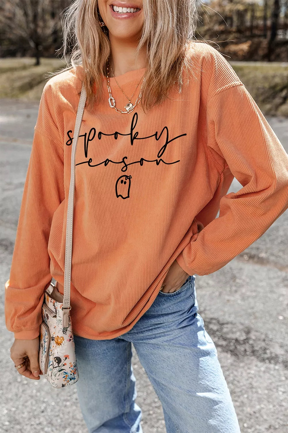 Orange ribbed pullover sweatshirt with spooky “sprooky season” graphic and long sleeves